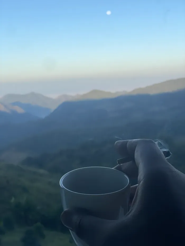Morning tea, mountains layered below