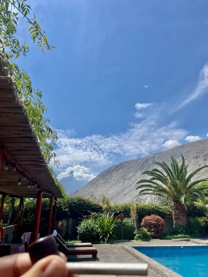 LunahuanΓ‘ pool with palms and Andes