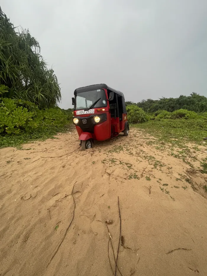 Red tuk tuk off-road on the dunes